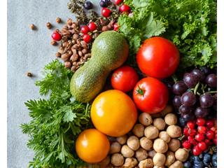 A diverse assortment of fresh ingredients suitable for various diets, such as leafy greens, nuts, and exotic fruits.