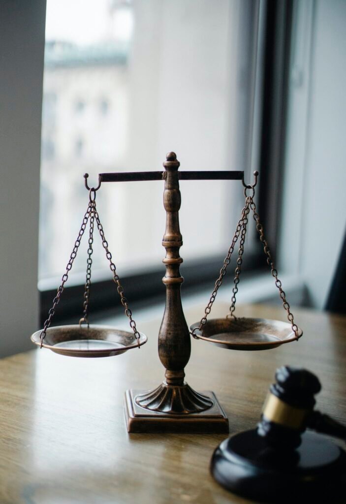 Decorative judgement scale and gavel placed on desk in light lawyer office against window - ethics in recovery coaching Explore essential legal and ethical considerations in recovery coaching, ensuring professional integrity and effective client relationships