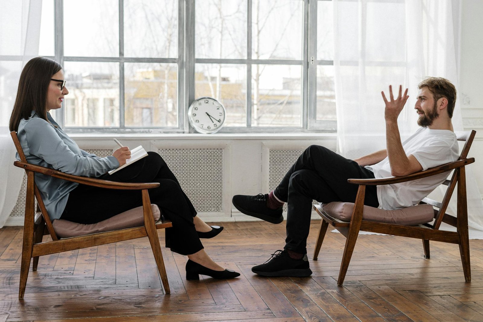 Person in Black Pants and Black Shoes Sitting on Brown Wooden Chair Supplement Recovery Coaching Article