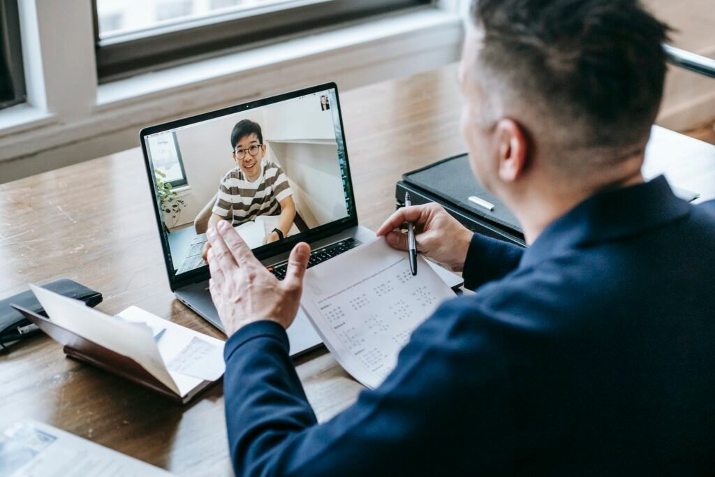 Photo Of Professor Teaching His Student signifying a coach or sponsor